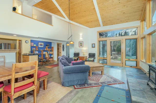 a living room with furniture and a book shelf