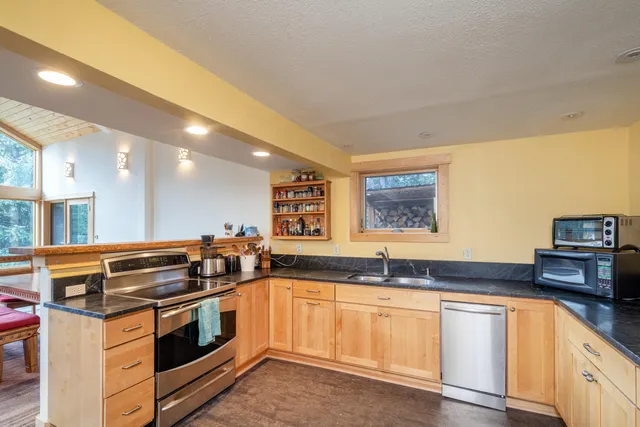a kitchen with granite countertop a stove and a sink