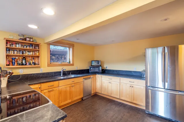 a kitchen with stainless steel appliances granite countertop a sink and cabinets