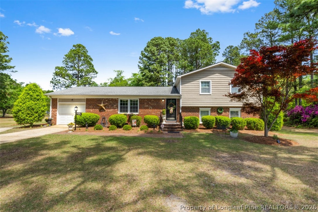 310 Canady Street Fayetteville, NC 28306 - Photo 1 of 50 a front view of a house with a yard and potted plants
