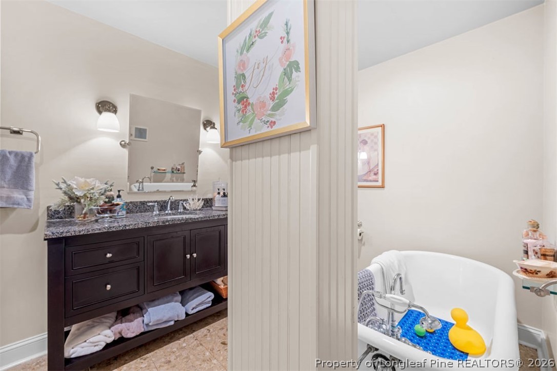 310 Canady Street Fayetteville, NC 28306 - Photo 17 of 50 a bathroom with a sink a vanity and a mirror