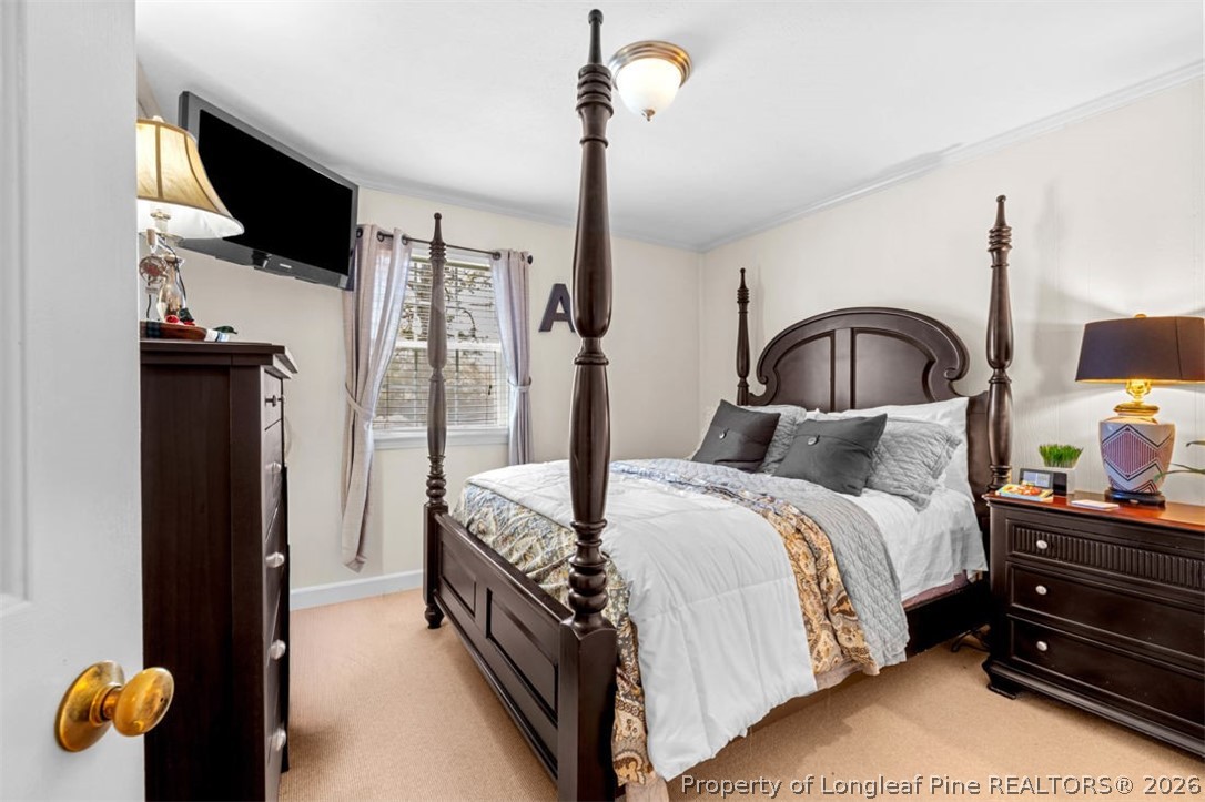 310 Canady Street Fayetteville, NC 28306 - Photo 18 of 50 a bedroom with a bed and a flat tv screen