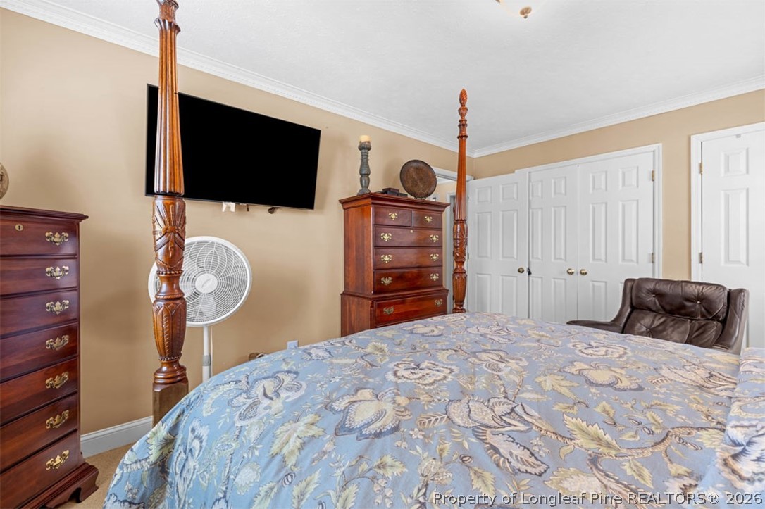 310 Canady Street Fayetteville, NC 28306 - Photo 20 of 50 a bedroom with a bed a flat screen tv and dresser