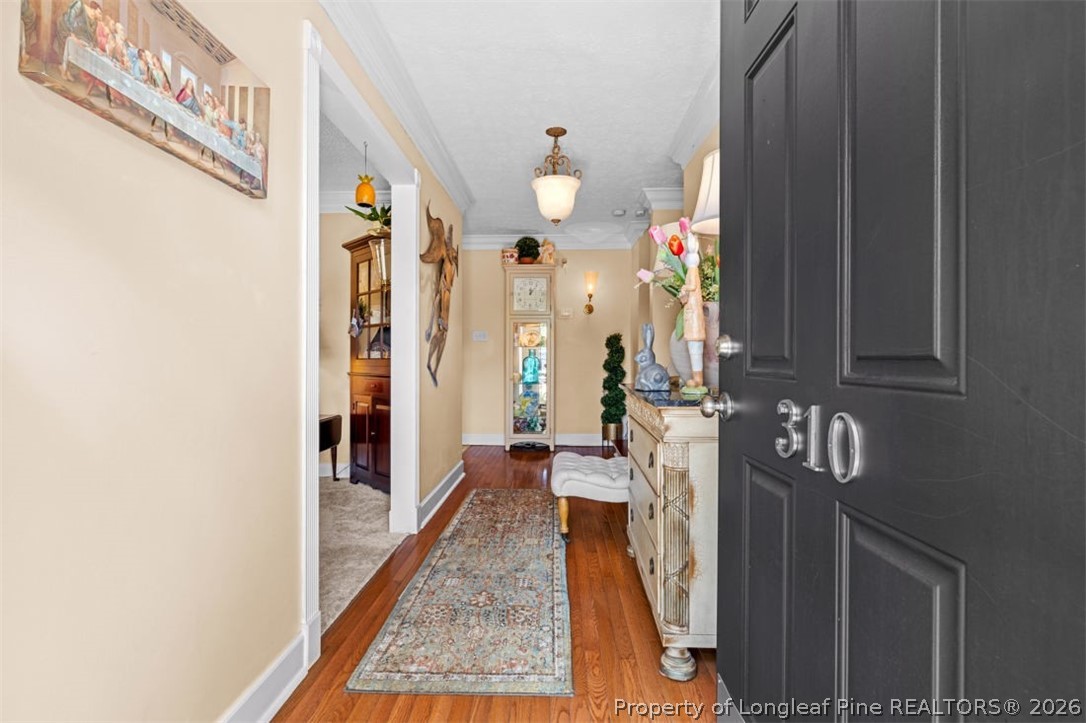 310 Canady Street Fayetteville, NC 28306 - Photo 2 of 50 a view of a hallway with wooden floor and staircase