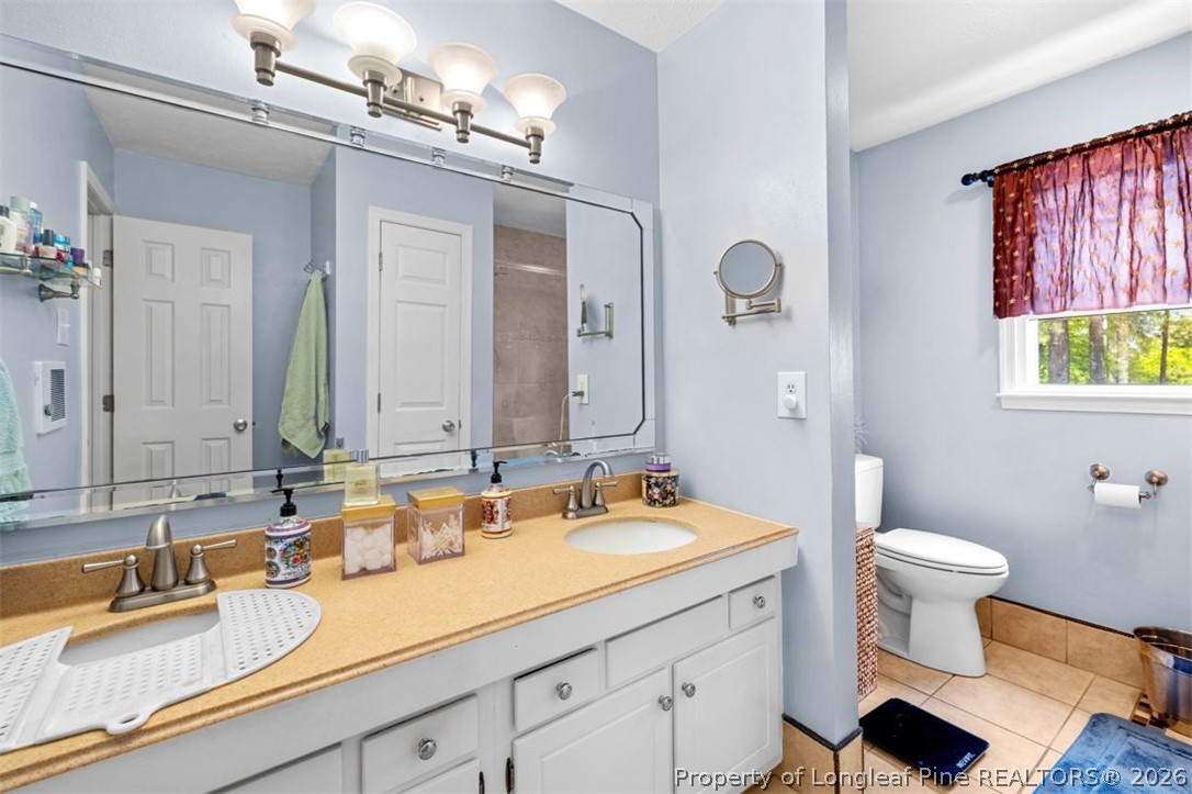 310 Canady Street Fayetteville, NC 28306 - Photo 22 of 50 a bathroom with a sink and a mirror