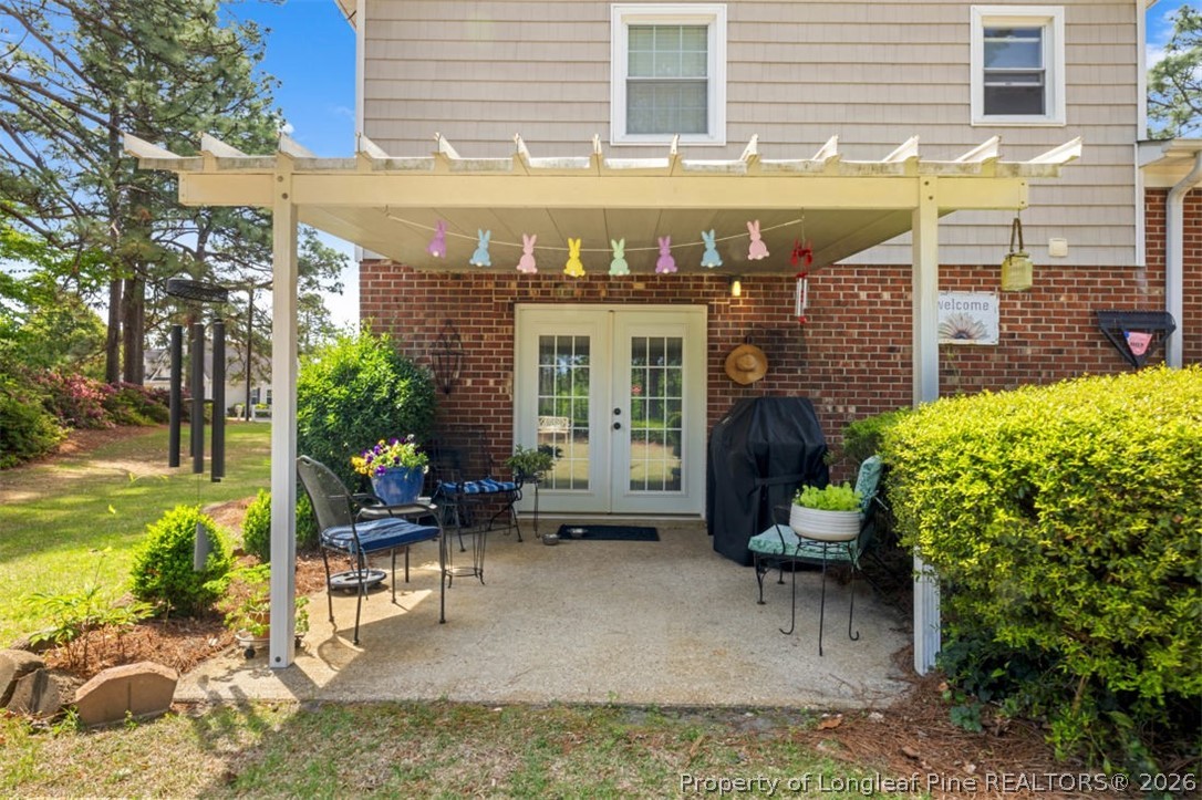 310 Canady Street Fayetteville, NC 28306 - Photo 24 of 50 a view of a patio with table and chairs and potted plants