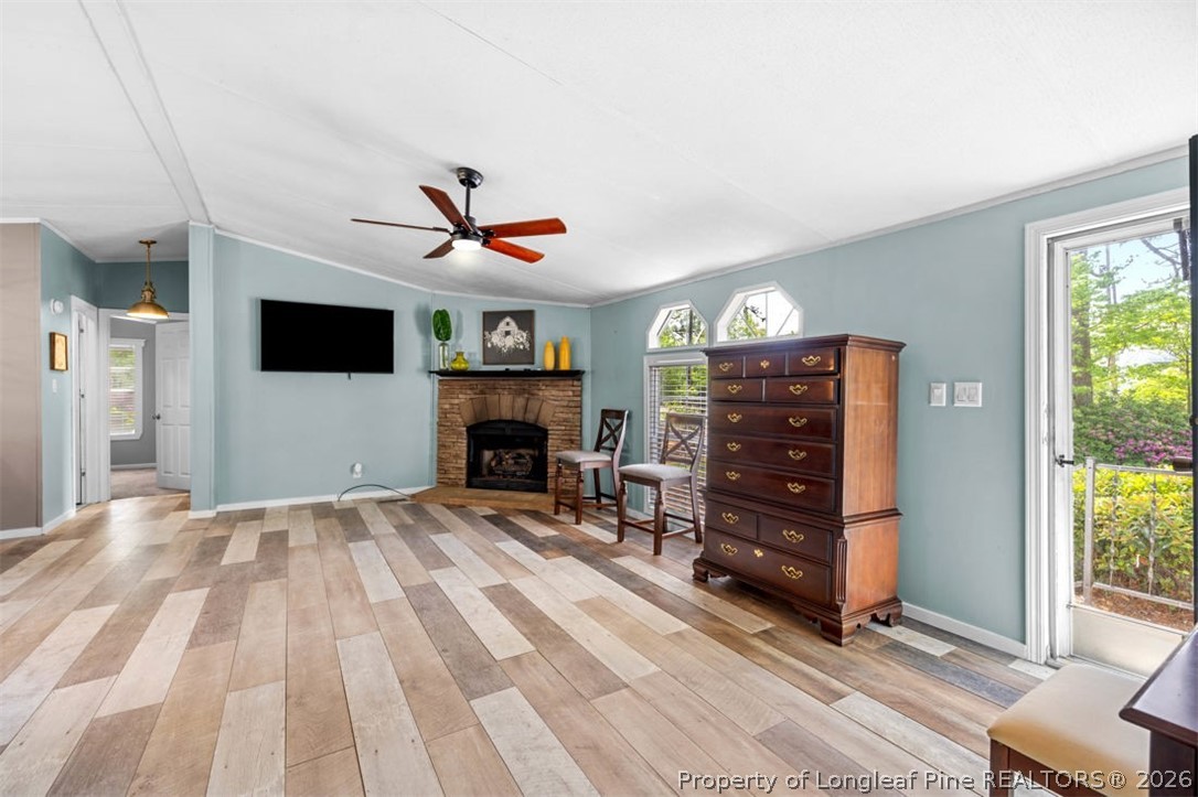 310 Canady Street Fayetteville, NC 28306 - Photo 29 of 50 a living room with furniture a fireplace and a flat tv screen