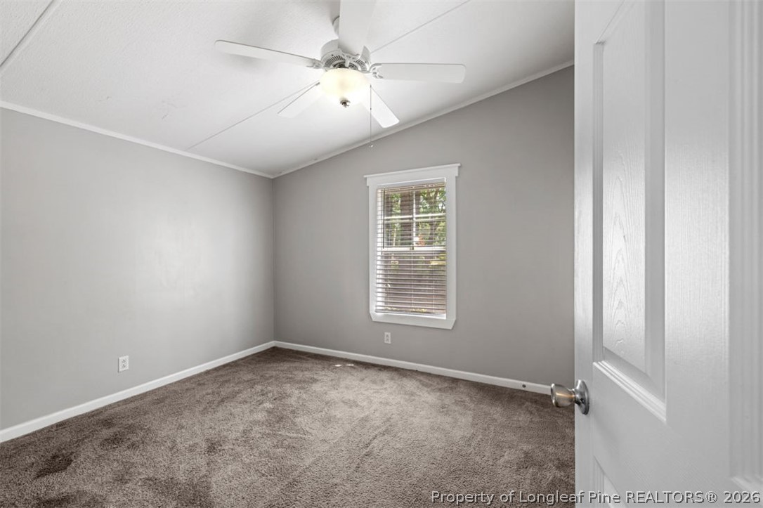 310 Canady Street Fayetteville, NC 28306 - Photo 34 of 50 an empty room with windows and fan