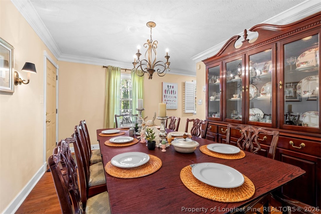 310 Canady Street Fayetteville, NC 28306 - Photo 8 of 50 a view of a dining room with furniture wooden floor and a chandelier