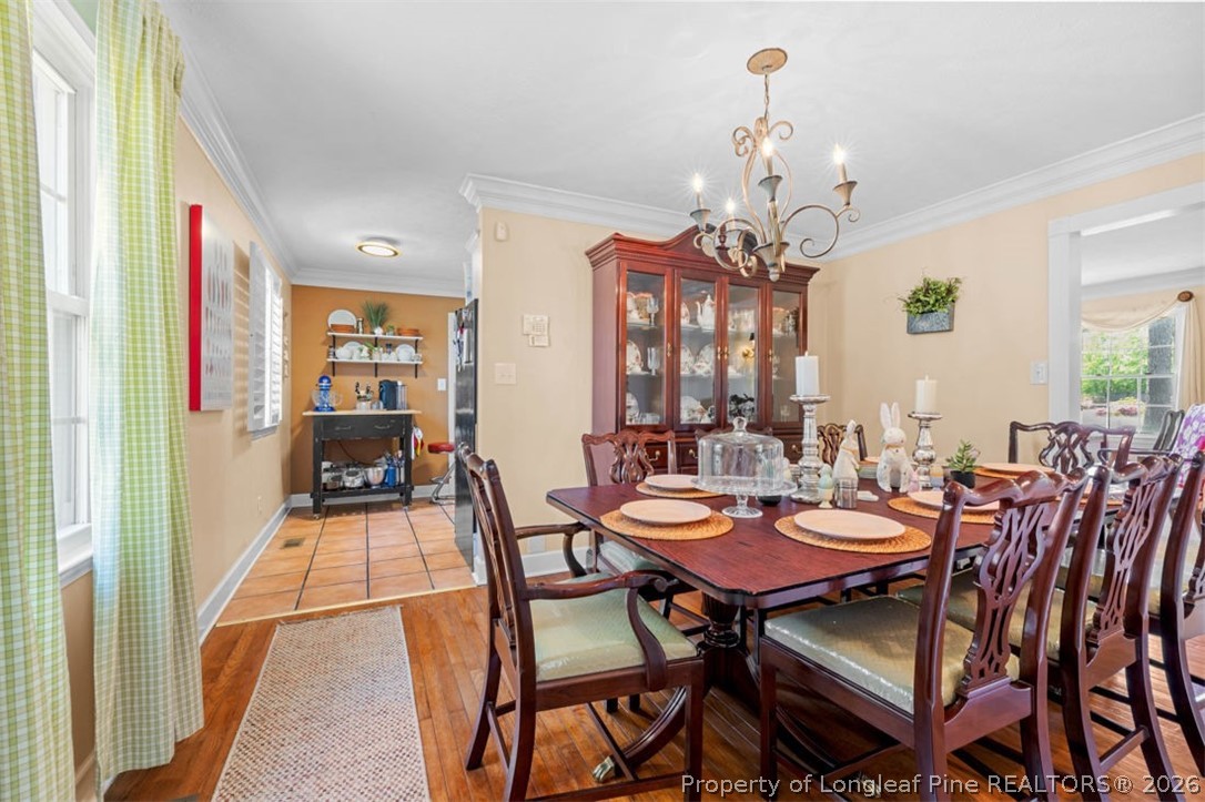 310 Canady Street Fayetteville, NC 28306 - Photo 9 of 50 a dining room with furniture a chandelier and wooden floor