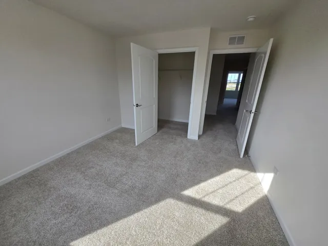 a view of a hallway with wooden floor and a hallway