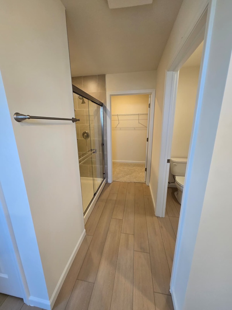 668 Switchgrass Way, Unit 58004 Bolingbrook, IL 60490 - Photo 27 of 31 a view of a hallway with wooden floor and a hallway