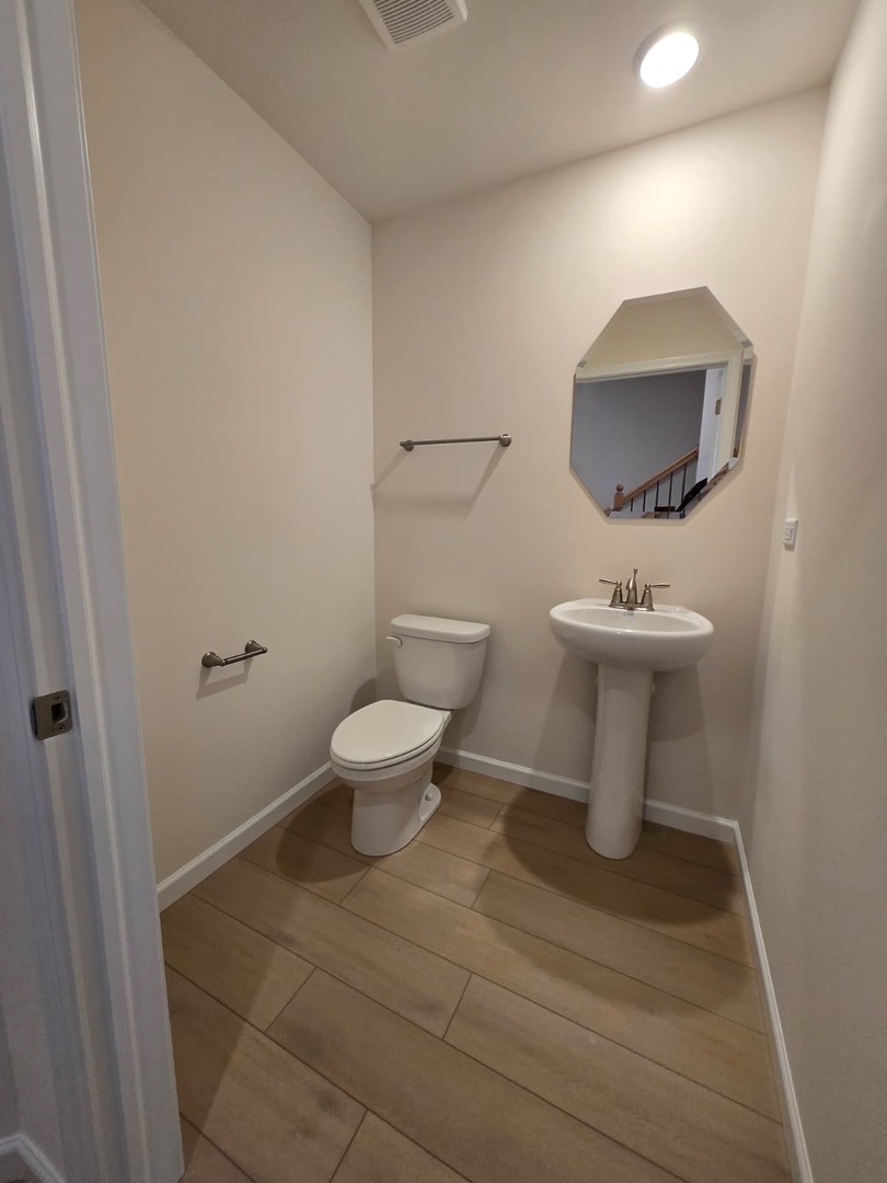 668 Switchgrass Way, Unit 58004 Bolingbrook, IL 60490 - Photo 30 of 31 a bathroom with a toilet