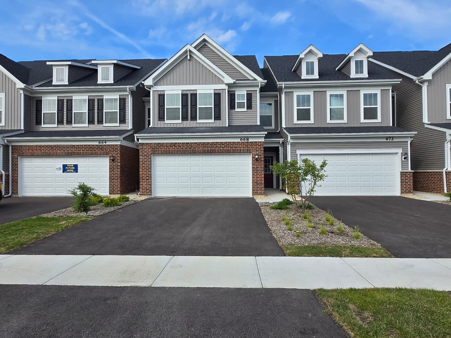 668 Switchgrass Way, Unit 58004 Bolingbrook, IL 60490 - Photo 3 of 31 a front view of a house with a yard and garage
