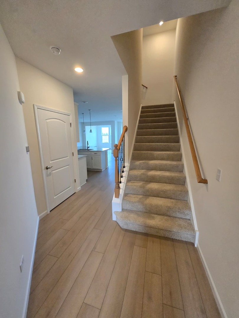 668 Switchgrass Way, Unit 58004 Bolingbrook, IL 60490 - Photo 5 of 31 a view of entryway and hall with wooden floor