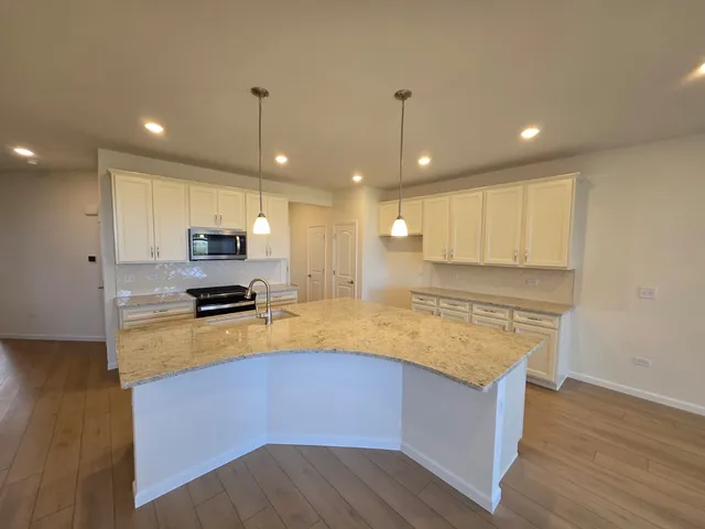 a kitchen with stainless steel appliances a stove sink and microwave