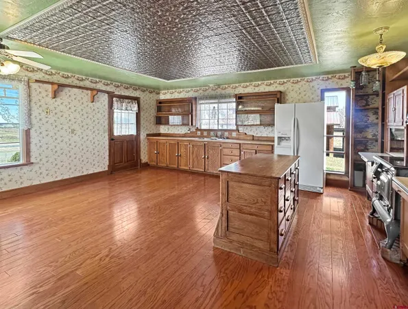 a dining room with furniture and wooden floor