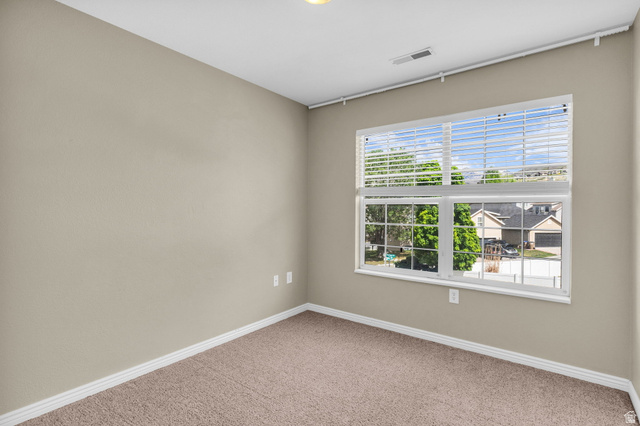 14108 Pepi Band Road Draper, UT 84020 - Photo 25 of 36 Neutral tone wall paint with white baseboards and textured carpeting
