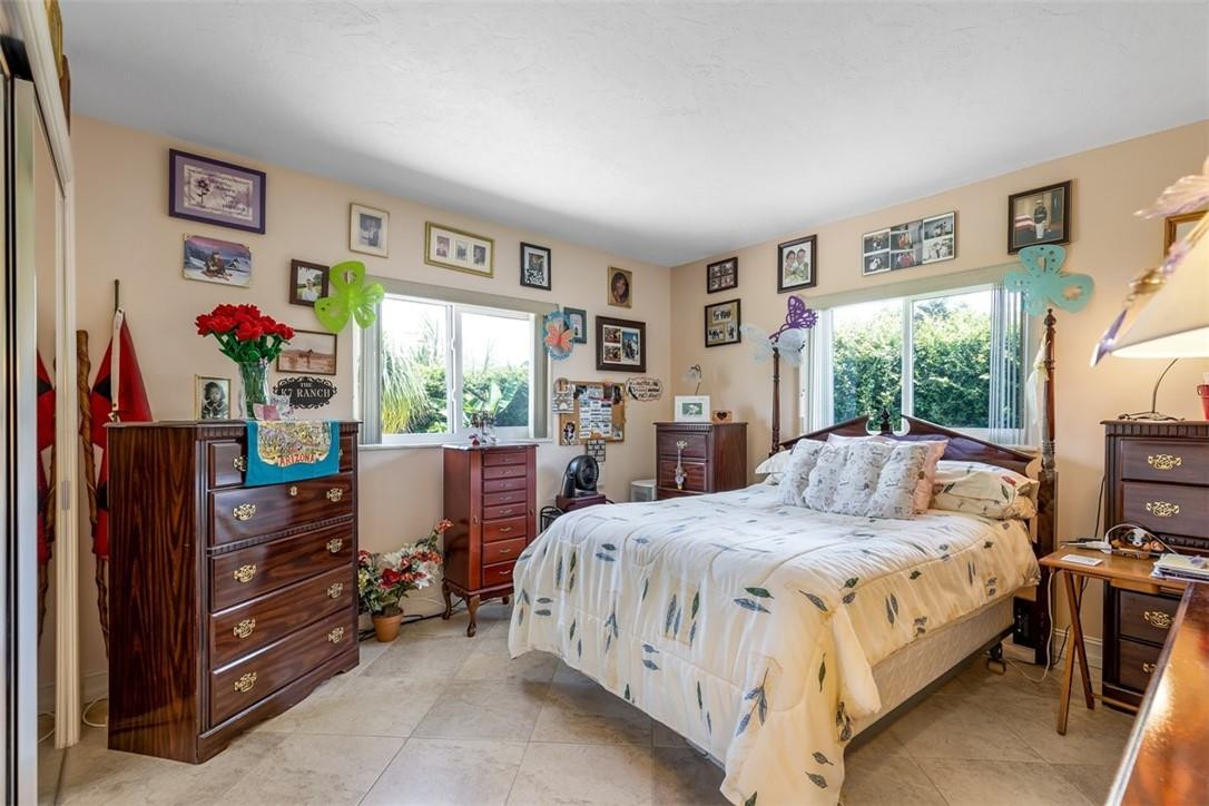 4625 Appalachian Street Boca Raton, FL 33428 - Photo 20 of 24 a bedroom with a bed and a window