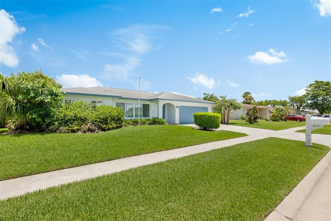 4625 Appalachian Street Boca Raton, FL 33428 - Photo 3 of 24 a front view of a house with a yard and garage