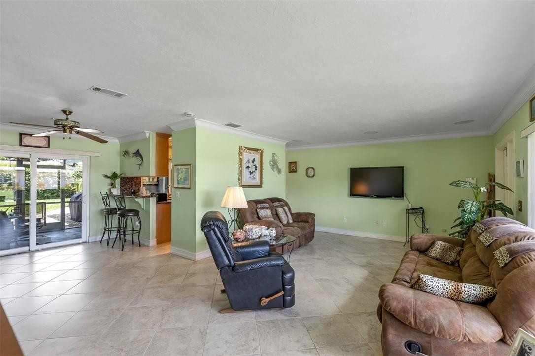4625 Appalachian Street Boca Raton, FL 33428 - Photo 5 of 24 a living room with furniture and a flat screen tv