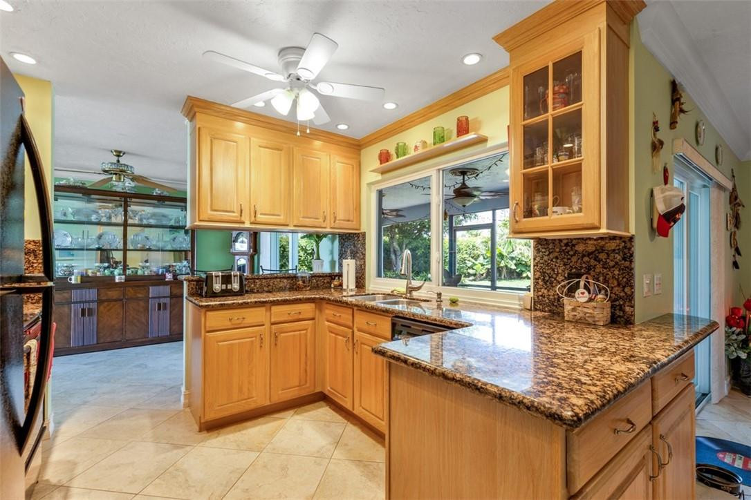 4625 Appalachian Street Boca Raton, FL 33428 - Photo 7 of 24 a kitchen with stainless steel appliances granite countertop a sink and a counter