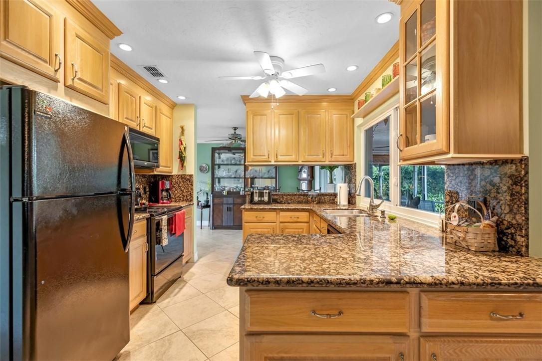 4625 Appalachian Street Boca Raton, FL 33428 - Photo 8 of 24 a kitchen with granite countertop a refrigerator and a sink