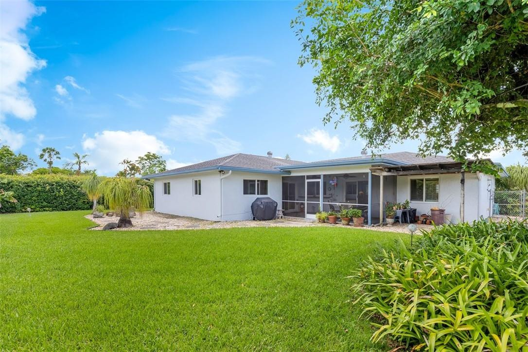 4625 Appalachian Street Boca Raton, FL 33428 - Photo 10 of 24 a front view of a house with a yard and green space