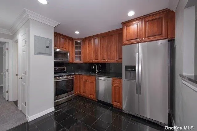 a kitchen with stainless steel appliances granite countertop a refrigerator stove and sink