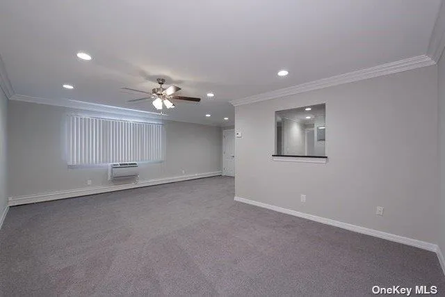a view of a livingroom with a ceiling fan and window