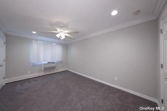 an empty room with a ceiling fan and window