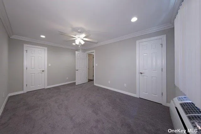 an empty room with closet and a ceiling fan