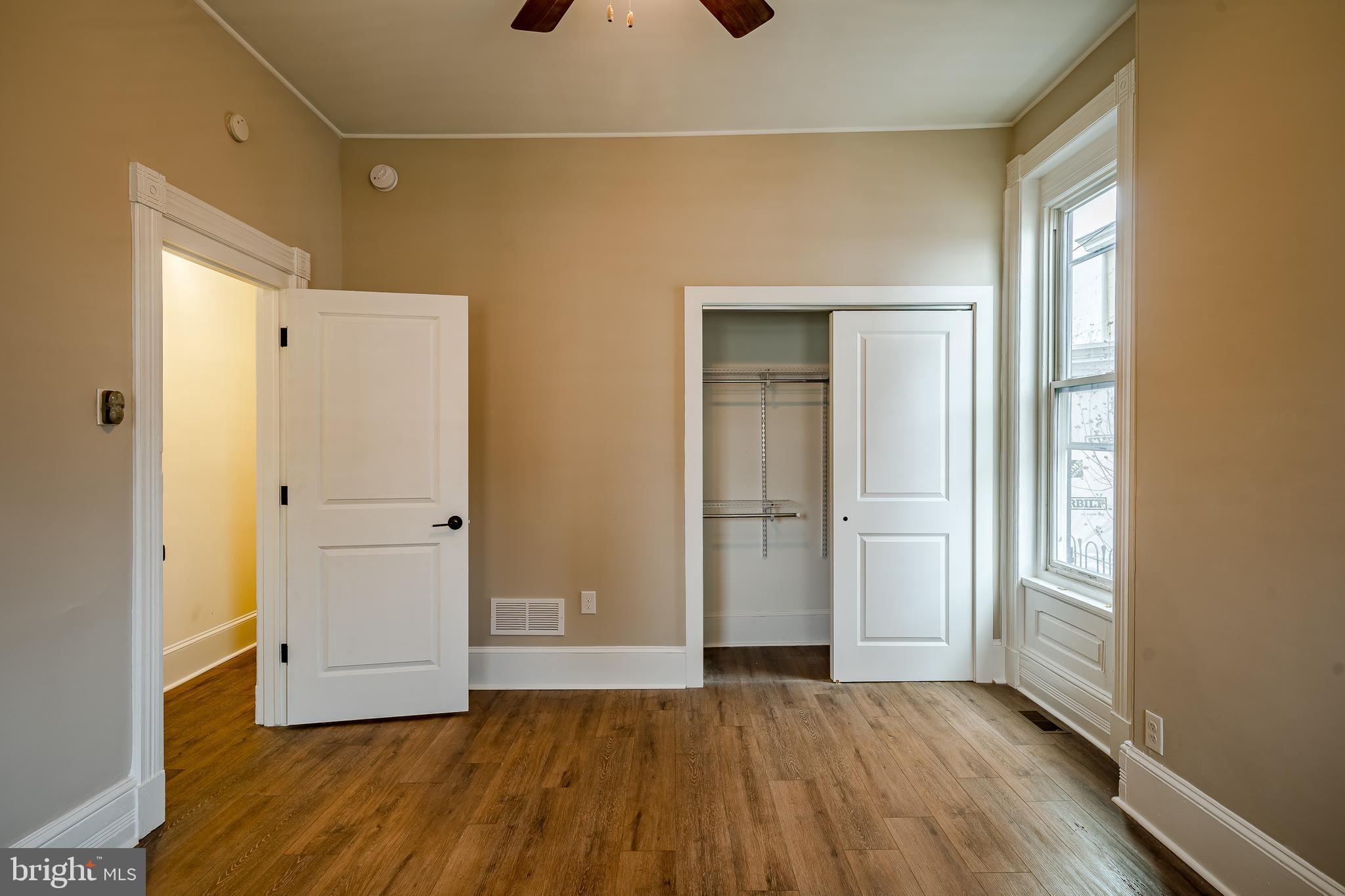 144 Gay Street, Unit 1 Phoenixville, PA 19460 - Photo 13 of 22 an empty room with wooden floor and windows