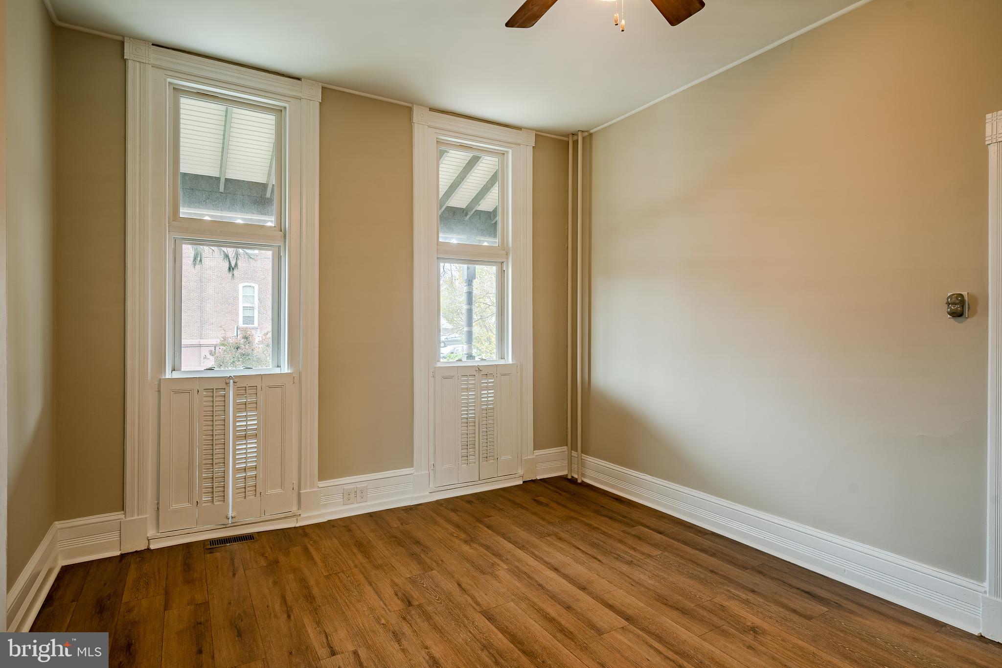 144 Gay Street, Unit 1 Phoenixville, PA 19460 - Photo 14 of 22 a view of an empty room with wooden floor and a window