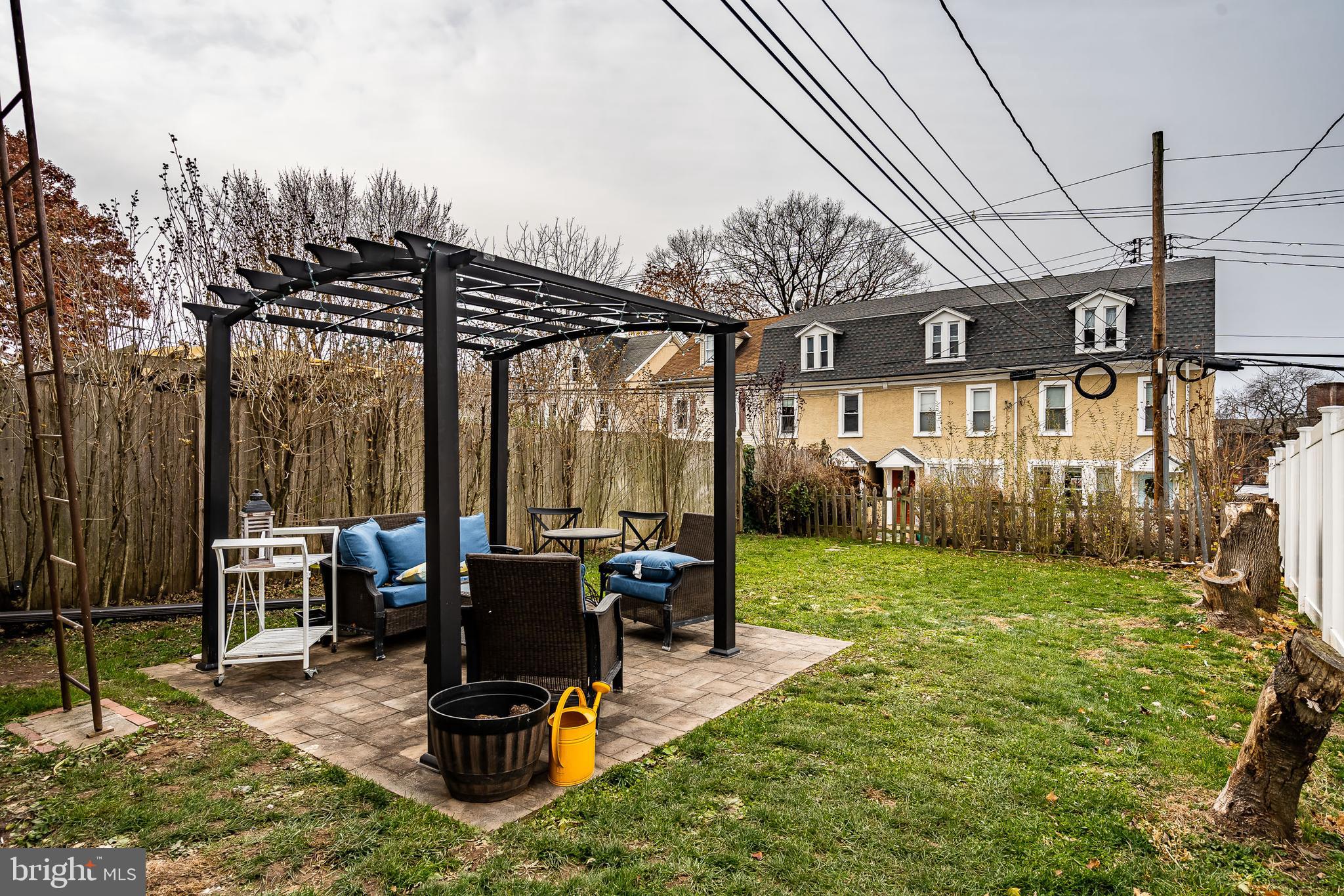 144 Gay Street, Unit 1 Phoenixville, PA 19460 - Photo 18 of 22 a view of a patio with table and chairs a barbeque with wooden fence