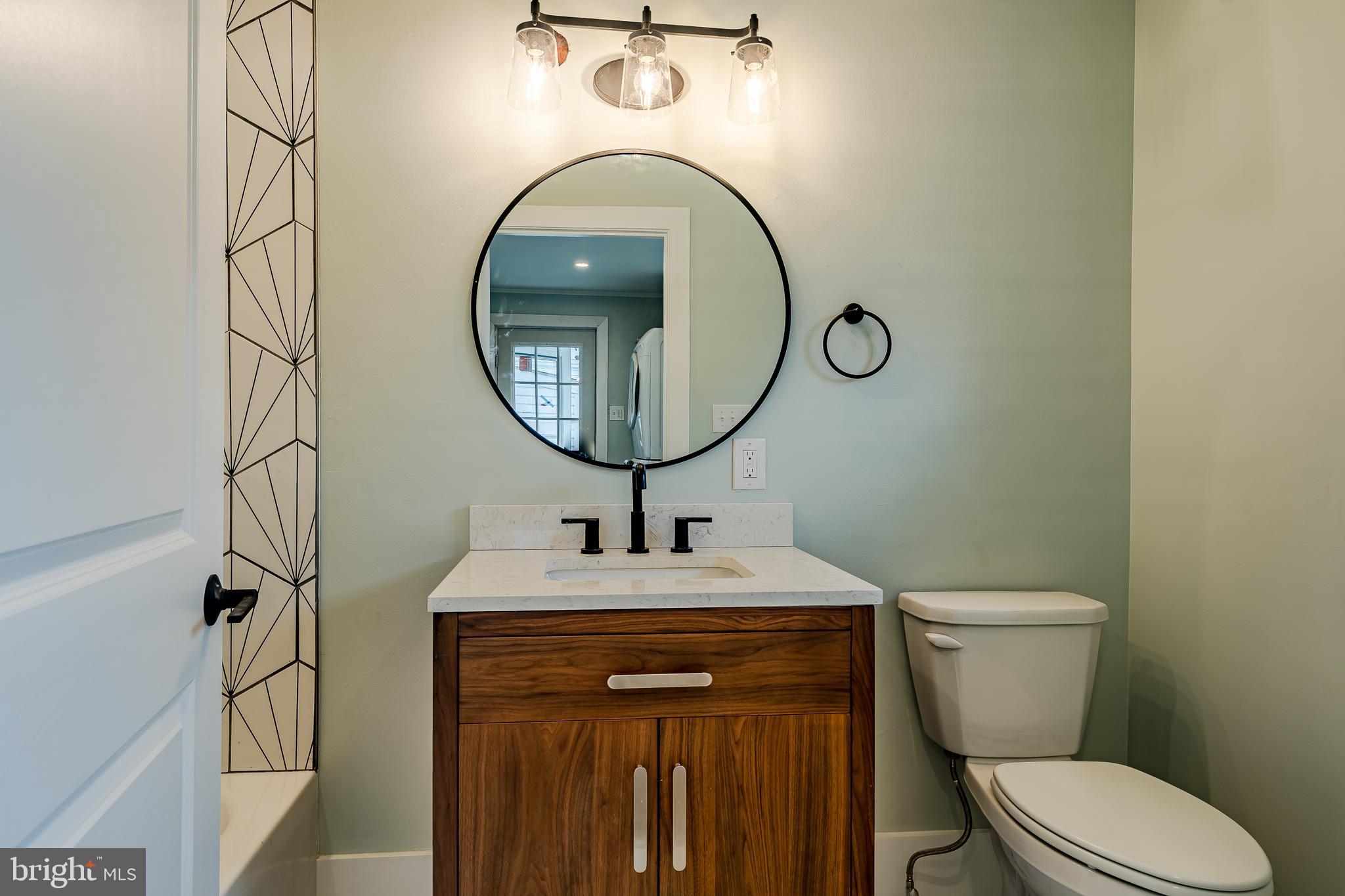 144 Gay Street, Unit 1 Phoenixville, PA 19460 - Photo 8 of 22 a bathroom with a toilet sink and mirror