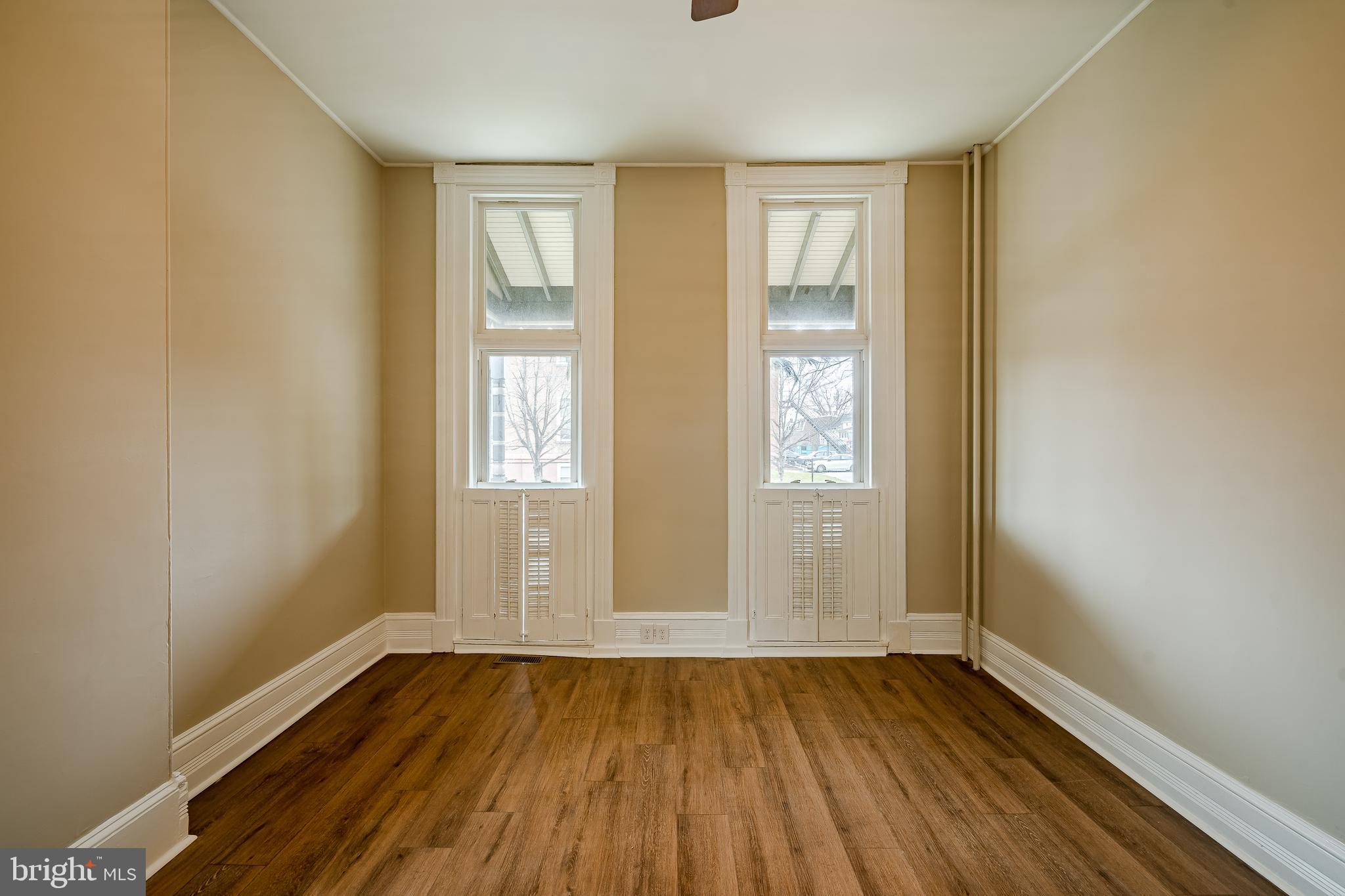 144 Gay Street, Unit 1 Phoenixville, PA 19460 - Photo 10 of 22 an empty room with wooden floor and windows