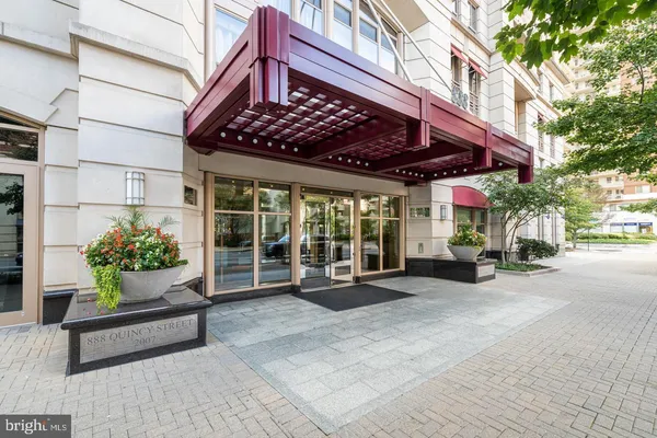 a view of a chairs and table in the patio and a fountain