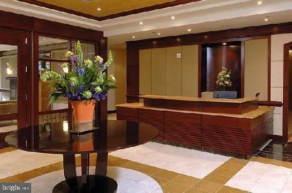 a room with painting and a potted plant