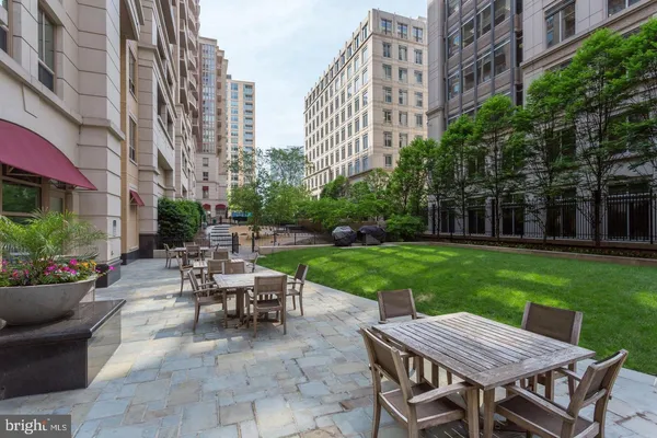 a view of a patio with a table and chairs and a yard