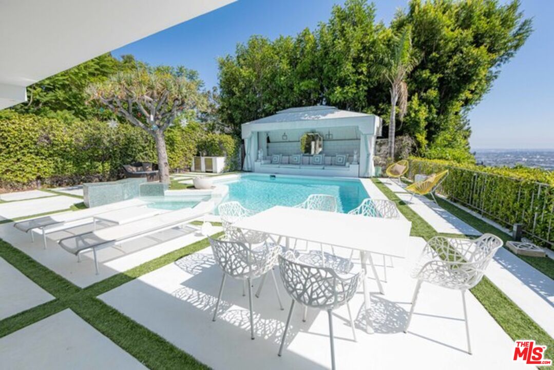 1425 Devlin Drive Los Angeles, CA 90069 - Photo 13 of 15 a view of a house with pool and chairs