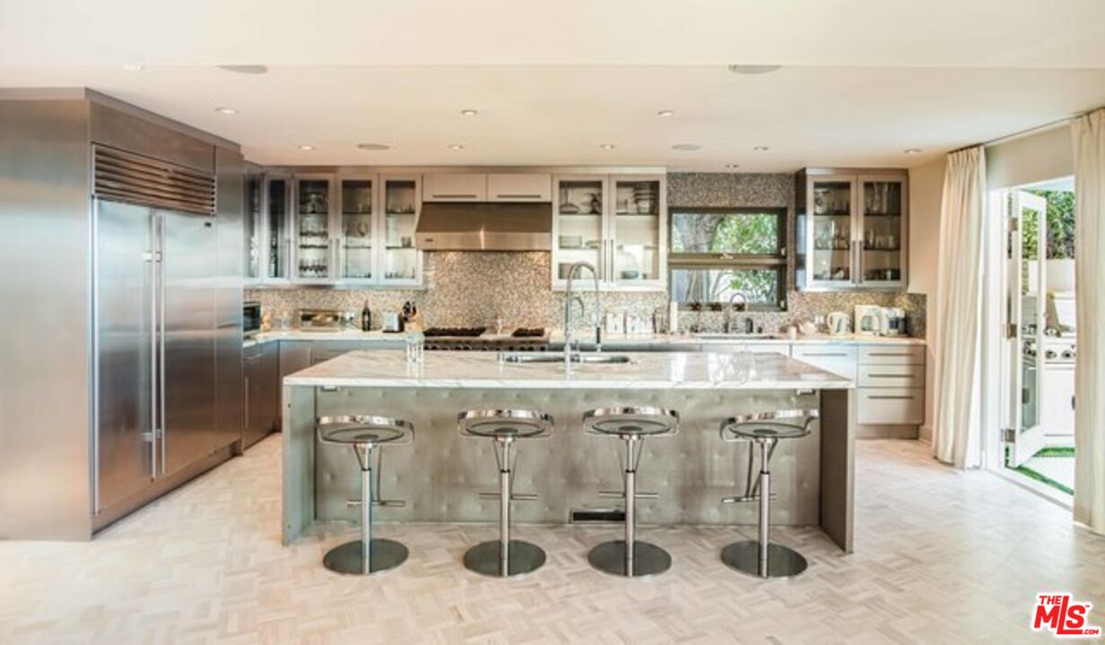 1425 Devlin Drive Los Angeles, CA 90069 - Photo 6 of 15 a kitchen with stainless steel appliances granite countertop a sink and a refrigerator