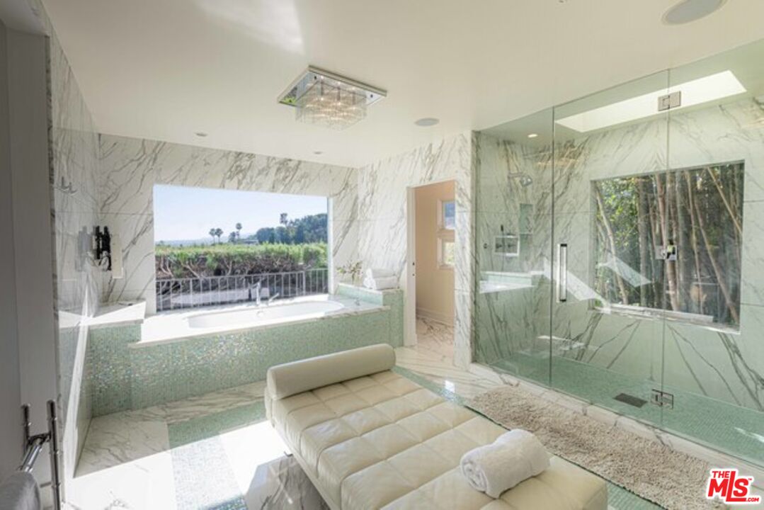 1425 Devlin Drive Los Angeles, CA 90069 - Photo 8 of 15 a bathroom with a glass shower door and a glass door