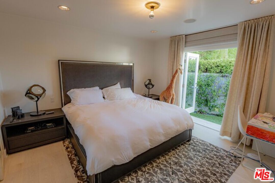 1425 Devlin Drive Los Angeles, CA 90069 - Photo 9 of 15 a bedroom with a bed and a window