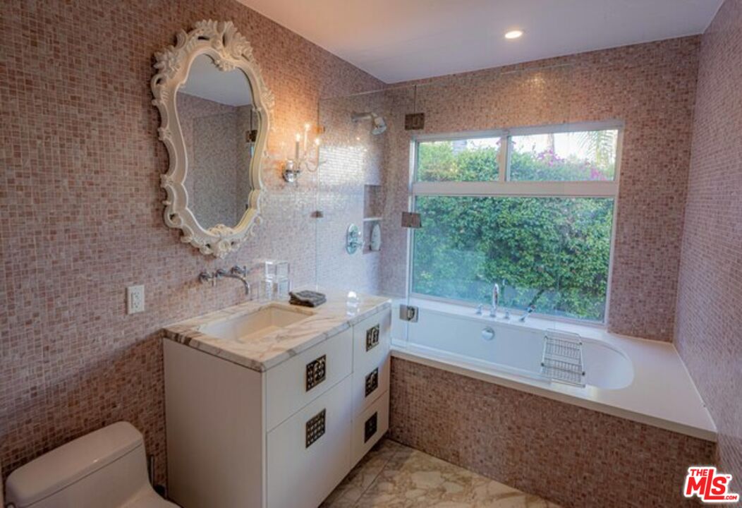1425 Devlin Drive Los Angeles, CA 90069 - Photo 10 of 15 a bathroom with a tub sink and mirror