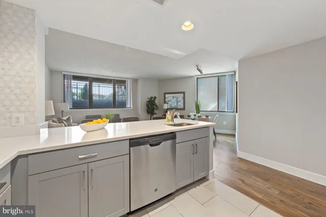 a view with double vanity sink a mirror and a window