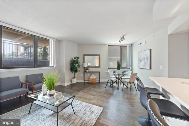 a living room with furniture and wooden floor