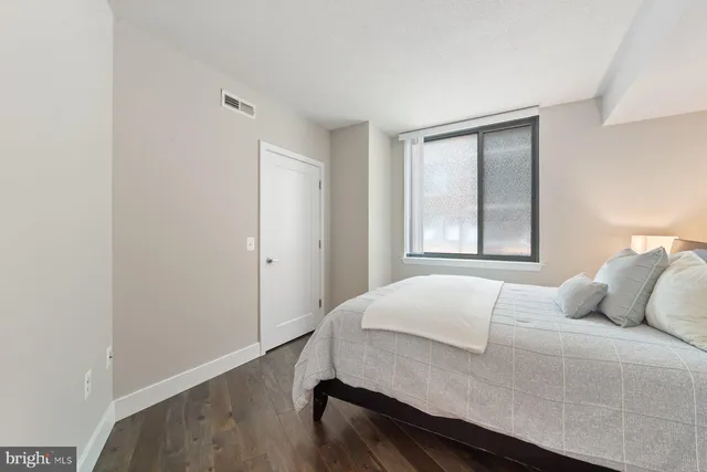 a bedroom with a bed and a window