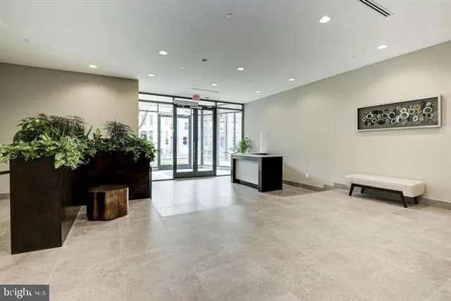 a lobby with furniture and potted plant