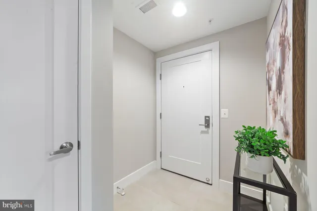 a view of a hallway with potted plant and stairs
